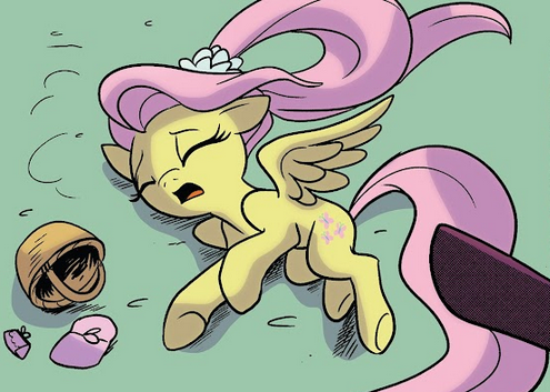 Fluttershy lying on the ground, with Opaline's hoof nearby.